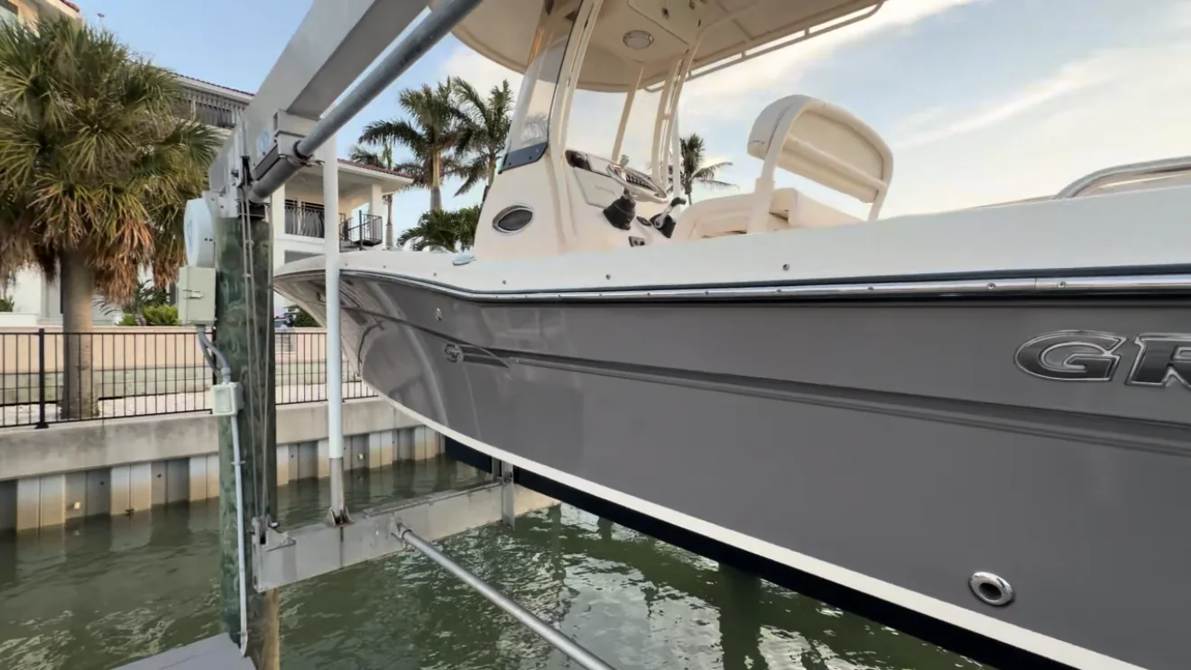The same gray boat hull after oxidation correction, with restored clarity and gloss