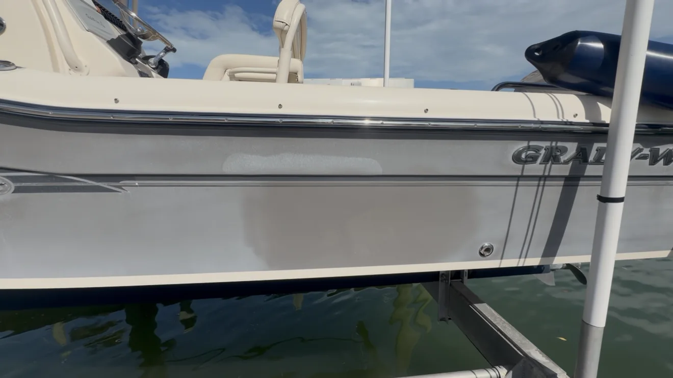 Gray boat hull before oxidation correction, with a dull and uneven finish